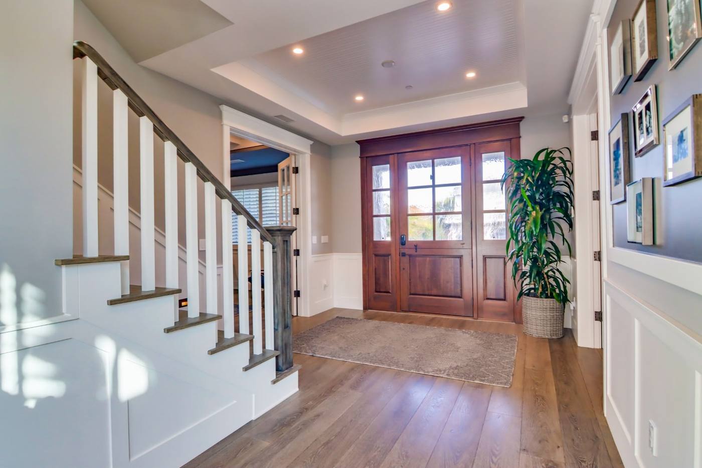 Entry hall with wood front door and painted stair