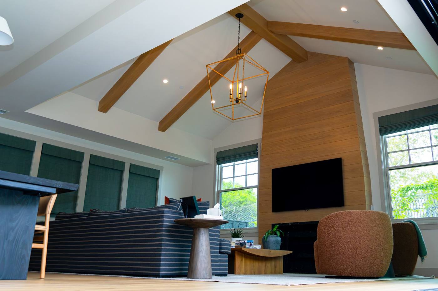 Great room with exposed beams and wood clad chimney