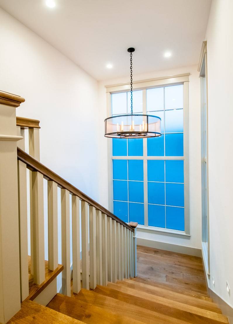 Custom hardwood staircase with painted rail