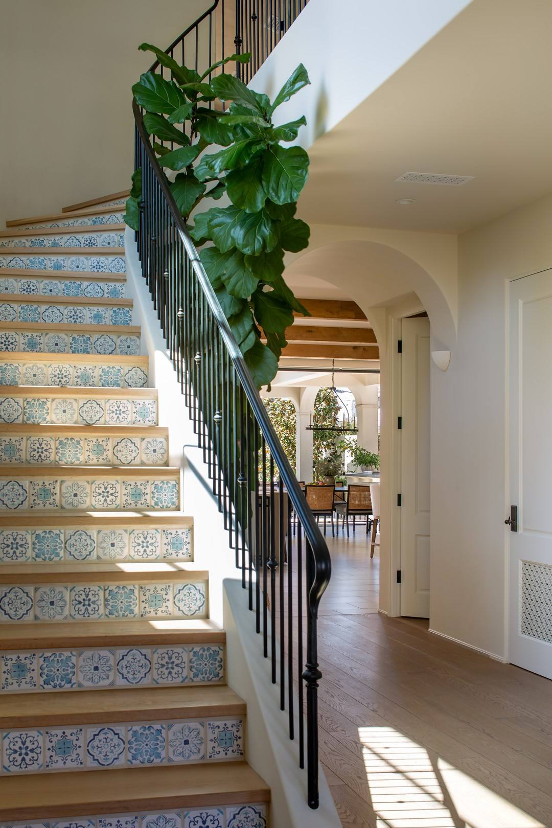 Stair with hand painted tile risers and iron rail